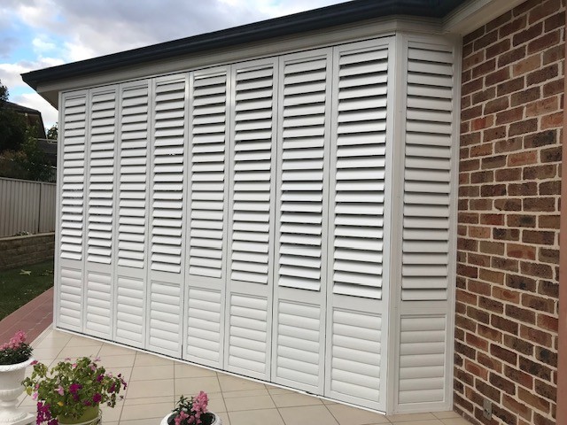 White plantation shutters installed across wide windows by Apollo Blinds Tamworth.