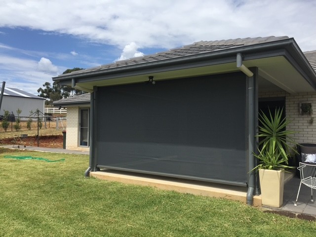 Large dark outdoor blind installed across a patio opening by Apollo Blinds Tamworth.